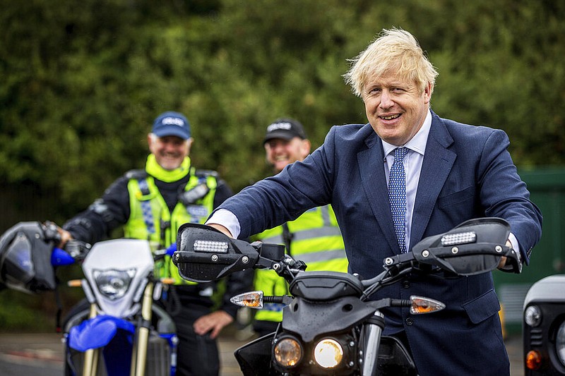 British Prime Minister Boris Johnson tries out a North Yorkshire Police Rural Taskforce electric bike during a visit to North Yorkshire Police headquarters in Northallerton, England, on Thursday, July 30, 2020.