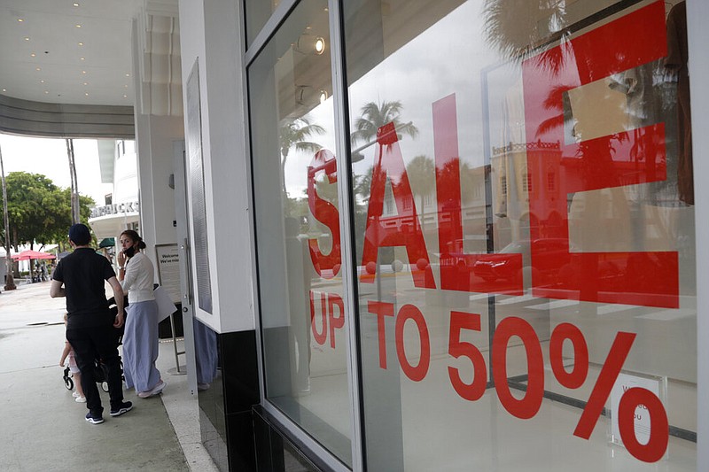 FILE - In this June 17, 2020 file photo, a sign advertises a sale at an H&M store along Lincoln Road Mall in Miami Beach, Fla. story.lead_photo.caption