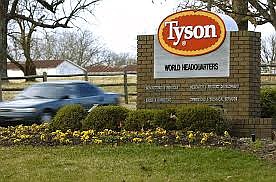 In this Jan. 29, 2006, file photo, a car passes in front of a Tyson Foods Inc., sign at Tyson headquarters in Springdale, Ark. Tyson Foods plans to administer thousands of coronavirus tests per week at its U.S. facilities under an expanded effort to protect workers and keep plants running. The Springdale, Arkansas-based company, which processes about 20% of all beef, pork and chicken in the U.S., on Wednesday, July 29, 2020, said it will randomly test employees who have no symptoms as well as those with symptoms. story.lead_photo.caption
