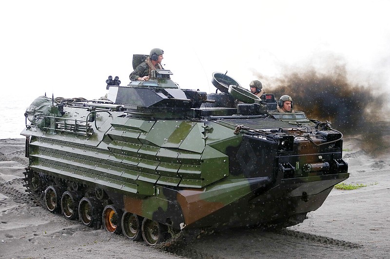 FILE - U.S. Marines from the 3rd Marine Expeditionary Brigade ride on their Amphibious Assault Vehicle (AAV) during the joint US-Philippines amphibious landing exercise Friday Oct.7, 2016 at Naval Education Training Command in San Antonio northwest of Manila, Philippines.