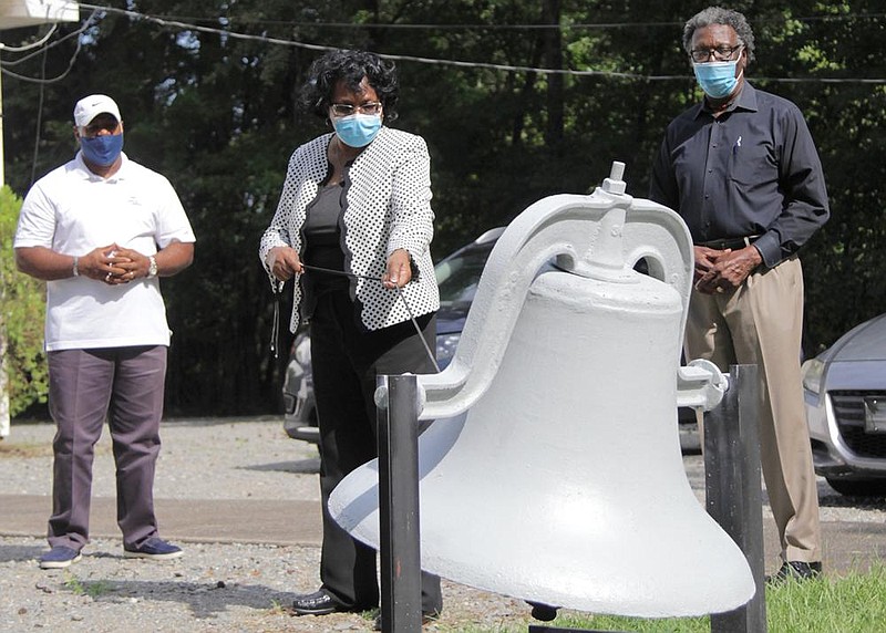 Barbara Douglas, senior pastor of St. Luke United Methodist Church in Pine Bluff, rings a bell Thursday in honor of the late John Lewis, a longtime congressman from Georgia’s 5th District and a civil-rights pioneer. Lewis’ funeral was Thursday. Joining Douglas in ringing the bell were R.L. Davis (left), pastor of Bethany Chapel, and Jesse Turner, pastor of Elm Grove Baptist Church.
(Arkansas Democrat-Gazette/Dale Ellis)