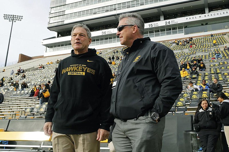 Iowa Coach Kirk Ferentz (left), shown here with Athletic Director Gary Barta, has led a football program which has suffered from racial bias against Black players and bullying by some current and former coaches, according to an investigation report released Thursday.
(AP file photo) story.lead_photo.caption