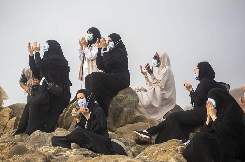 Muslims pray Thursday atop the rocky hill known as Mountain of Mercy on the Plain of Arafat during the annual hajj pilgrimage near the holy city of Mecca in Saudi Arabia. Hajj participation has been cut back this year because of the virus pandemic. More photos at arkansasonline.com/731covid/.
(AP/Saudi Ministry of Media)