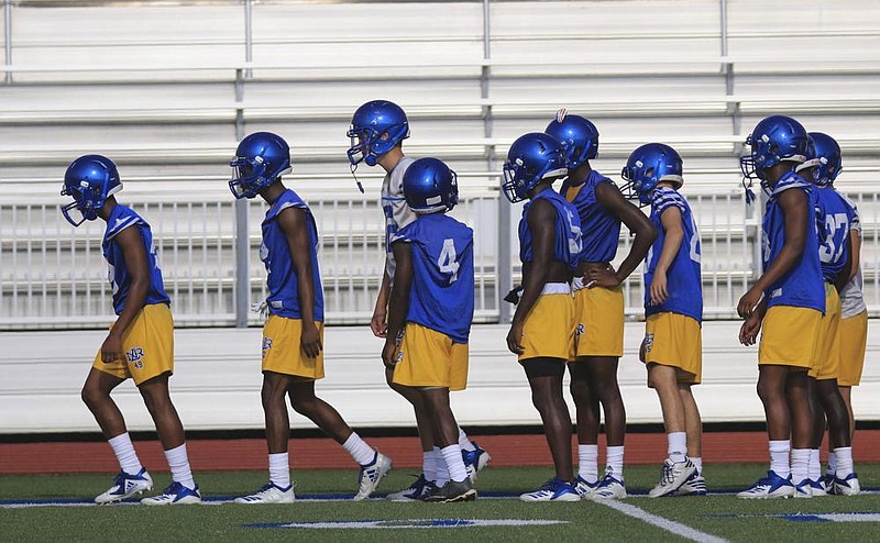 North Little Rock football players go through agility and conditioning drills on the first day of fall practice last August. Per an announcement by Arkansas Gov. Asa Hutchinson on Friday, teams can begin practicing with helmets Monday, the first date for fall practice on the Arkansas Activities Association’s 2020-21 calendar.
(Arkansas Democrat-Gazette/Staton Breidenthal)