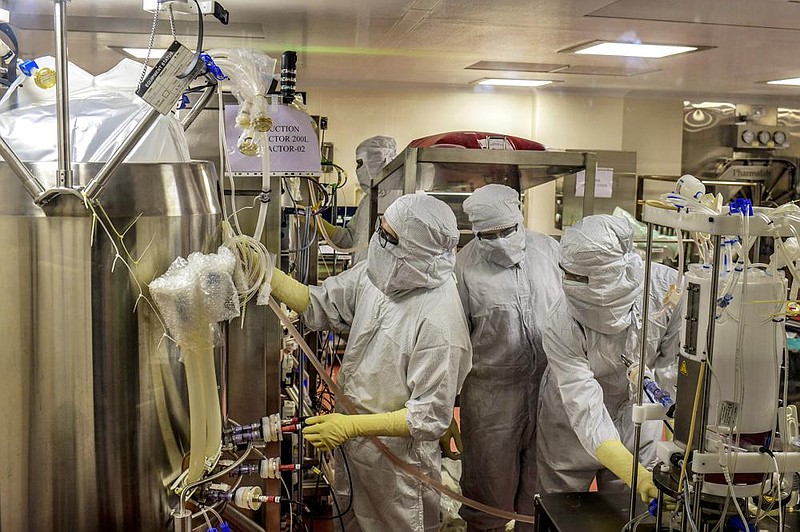 Researchers at the Serum Institute in Pune, India, work in mid-Ju- ly on a bioreactor to manufacture a possible coronavirus vaccine, still in clinical trials. The institute’s mammoth assembly lines are capable of producing 1.5 billion doses of vaccines a year. 
(The New York Times/Atul Loke) 