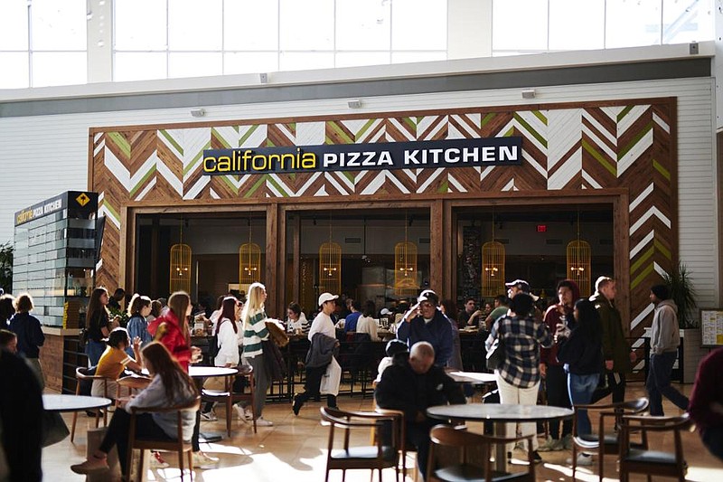 Shoppers walk past a California Pizza Kitchen restaurant at the West eld Garden State Plaza mall in Paramus, N.J., in November. (Bloomberg News/Gabby Jones) 