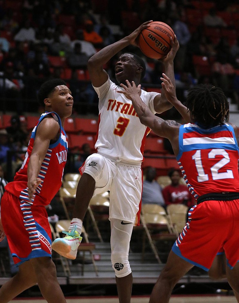 Jacksonville’s Davonte Davis (3) goes up for a shot between Memphis Wood- dale’s Santerrio Brown (55) and Anaias Bennett (12) during Jacksonville’s 75-72 victory in the 2019 King Cotton Classic at the Pine Bluff Convention Center. Organizers have canceled this year’s King Cotton Classic because of the coronavirus pandemic. 
(Arkansas Democrat-Gazette/Thomas Metthe) 
