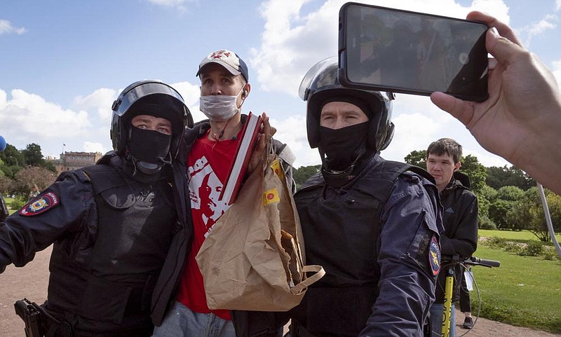 Police detain a protester Saturday in St. Petersburg, Russia, during a rally in support of Ser- gei Furgal, the jailed governor of the Khabarovsk Krai region. More photos at arkansasonline. com/82khabarovsk/. (AP/Dmitri Lovetsky) 