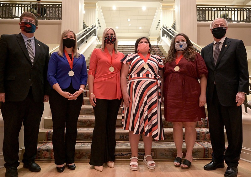 Arkansas Education Secretary Johnny Key (from left) stands Friday with Teacher of the Year semi finalists Susanna Post, Tia Brickey, Susan Henderson and Amber Harbin and with Gov. Asa Hutchinson. (Arkansas Democrat-Gazette/Stephen Swofford) 
