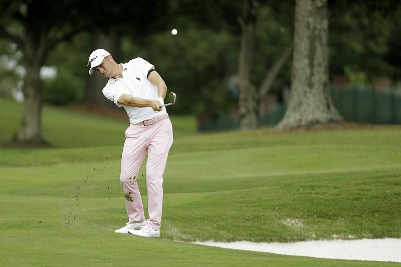 Justin Thomas hits from the rough on the 16th hole during the final round of the St. Jude In- vitational on Sunday in Memphis. Thomas’ fi- nal-round 5-under 66 gave him the victory and boosted him to the top spot in the world rankings for the first time since June 2018. More photos at arkansasonline.com/83invitational/ (AP/Mark Humphrey) 
