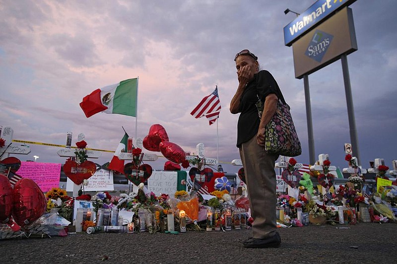 Catalina Saenz wipes tears from her face as she visits a makeshift memorial near the scene of a mass shooting at a shopping complex in El Paso, Texas, in this Aug. 6, 2019, le photo. (AP/John Locher) 