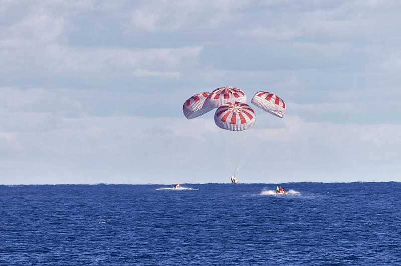 The SpaceX capsule splashes down Sunday in the Gulf of Mexico. More photos at arkansasonline. com/83spacex/ (AP/NASA/Cory Huston) 
