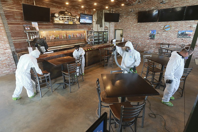 Workers from Servpro disinfect Mugshots restaurant in Tupelo, Mississippi, Friday, July 17, 2020, as the restaurant is preparing to open for business. 
