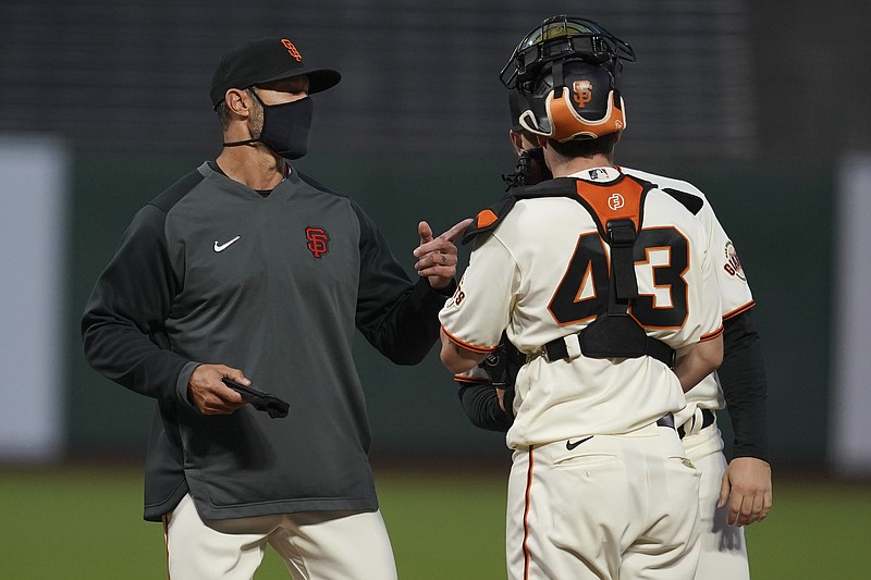 San Francisco Giants manager Gabe Kapler, left, talks with catcher Tyler Heineman (43) and pitcher Caleb Baragar during the fifth inning of a baseball game against the San Diego Padres in San Francisco, Thursday, July 30, 2020. 