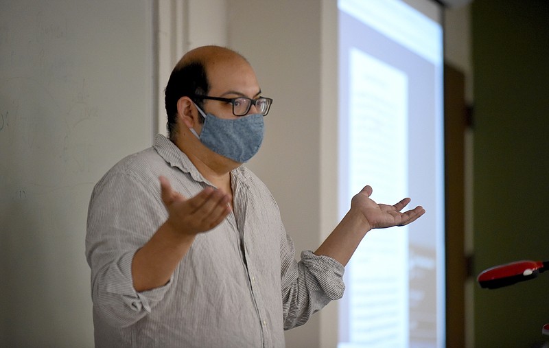 Professor Freddy Dominguez teaches the history course, Wars of Religion, Monday, August 3, 2020, the first day of a concentrated 10-day course that is part of the University of Arkansas' Intersession term. Students and Dominguez wore masks and where physically-distanced in the class in Kimpel Hall on the campus in Fayetteville. 
