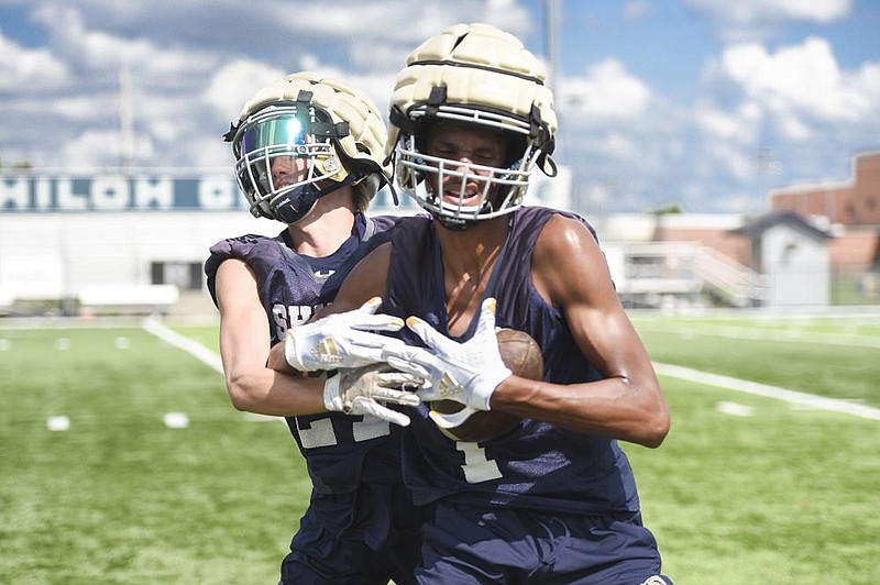Receiver Sawyer Shankle (27) (from left) and receiver Kahlil Mobley (1) struggle for possession of the ball, Monday, August 3, 2020 during a football practice at Shiloh Christian High School in Springdale. Check out nwaonline.com/200804Daily/ for today's photo gallery. 
(NWA Democrat-Gazette/Charlie Kaijo)