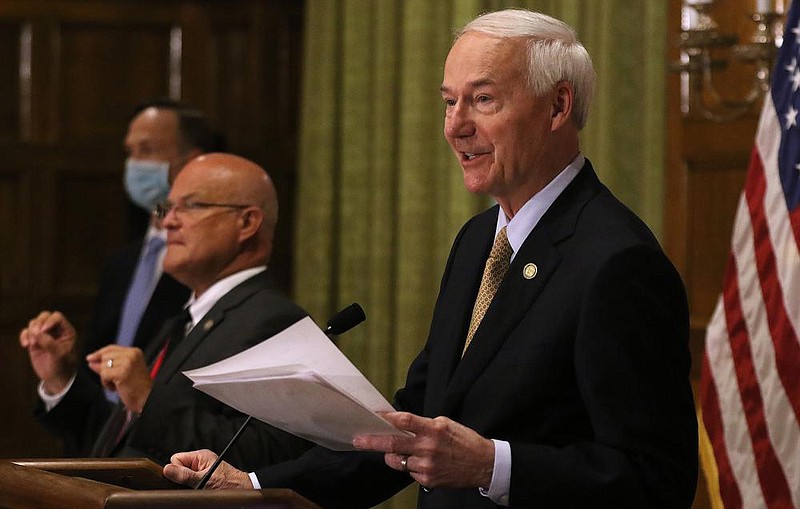 Gov. Asa Hutchinson gives the statistics of new COVID-19 cases during the daily COVID-19 press briefing on Wednesday, Aug. 5, at the state Capitol in Little Rock. (Arkansas Democrat-Gazette/Thomas Metthe)