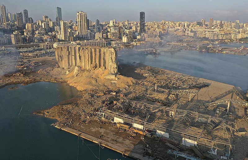 A drone-taken photo Wednesday shows some of the damage from explosions that rocked the seaport of Beirut on Tuesday. “Beirut as we know it is gone, and people won’t be able to rebuild their lives,” a resident said as she swept up shattered glass. More photos at arkansasonline.com/86beirut/.
(AP/Hussein Malla)