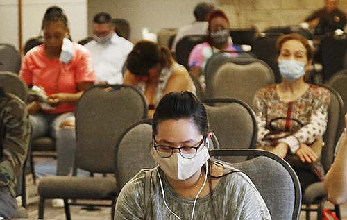 People wait to discuss unemployment claims at a state office in Midwest City, Okla., in July. A report by payroll processor ADP on hiring in July is just one indicator of the impact the coronavirus is having on the economy.
(AP/Sue Ogrocki)