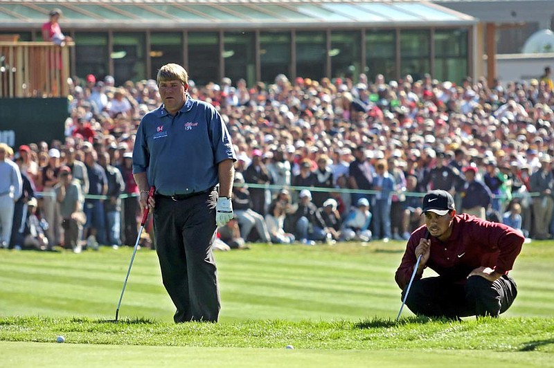 Dardanelle’s John Daly (left) and Tiger Woods line up putts during their sudden death playoff in the 2005 World Golf Championship at Harding Park in San Francisco, site of this week’s PGA Championship. On the second extra hole, Daly had a 15-foot birdie putt to win, but he missed that and a 3-foot par putt. Woods made par to win his 10th WGC title.
(AP file photo)