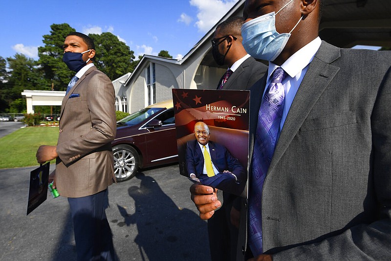 Attendees leave a public viewing for Herman Cain in Atlanta on Thursday, Aug. 6, 2020. The former Republican presidential candidate, radio host and entrepreneur died on July 30 after being hospitalized with covid-19. He was 74.