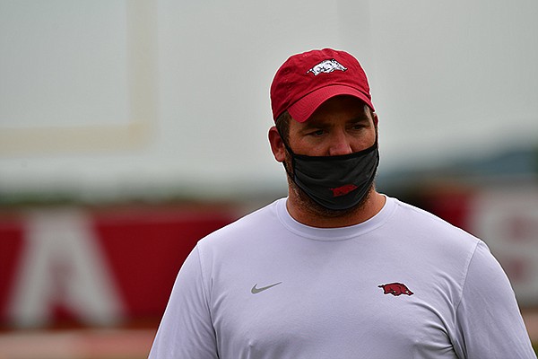 Arkansas tight ends coach Jon Cooper is shown during a July 2020 workout in Fayetteville. Face coverings like the one showed here will be required on the sidelines during football games this season to be in compliance with SEC playing protocols. 