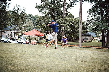 Daniel Green tees off on hole No. 5, while Patti Drake, in the background at left, and Chwanda Voque look on during last year’s annual Miracles Fore Mary Golf Tournament at the Country Club of Arkansas in Maumelle. This year’s event is scheduled for Aug. 22, and the cost to enter is $100 per person.