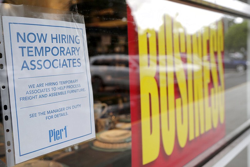 A sign advertises hiring of temporary associates at a Pier 1 retail store, which is going out of business, during the coronavirus pandemic, Thursday, Aug. 6, 2020, in Coral Gables, Fla.