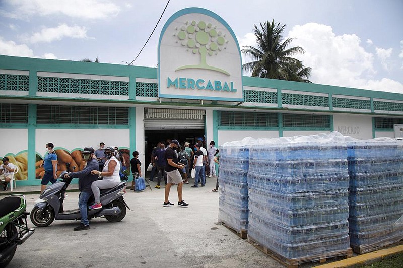 Shoppers wait to enter Mercabal wholesale market in Havana, Cuba, on July 31. The government is letting private businesses buy wholesale for the first time.
(AP/Ismael Francisco)