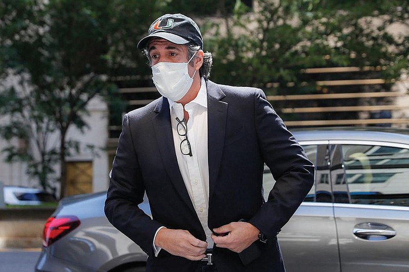 Michael Cohen arrives at his Manhattan apartment, Thursday, May 21, 2020, in New York.  President Donald Trump's longtime personal lawyer and fixer was released federal prison Thursday and is expected to serve the remainder of his sentence at home. Cohen has been serving a federal prison sentence at FCI Otisville in New York after pleading guilty to numerous charges, including campaign finance fraud and lying to Congress.   (AP Photo/John Minchillo)