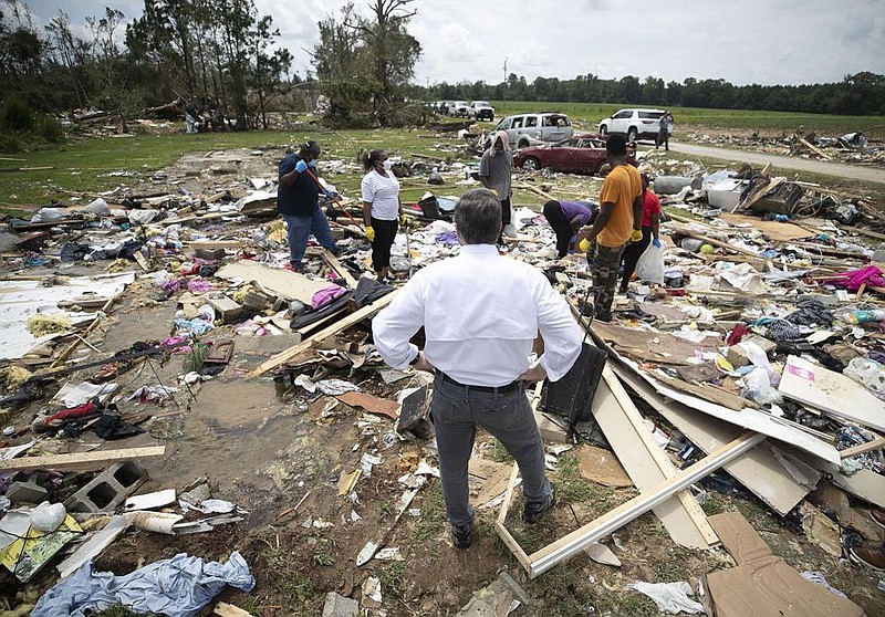 North Carolina Gov. Roy Cooper talks with residents of a rural mobile home neighborhood Wednesday near Windsor, N.C., as they look for personal items after a tornado spawned by Hurricane Isaias tore through the area Tuesday, killing two people.
(AP/The News & Observer/Robert Willett)
