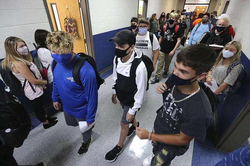 Eighth-graders change classes Thursday in Guntown, Miss., as others wait in their assigned spots against the wall on the first day back at school in the Lee County District.
(AP/The Northeast Mississippi Daily Journal/Adam Robison)