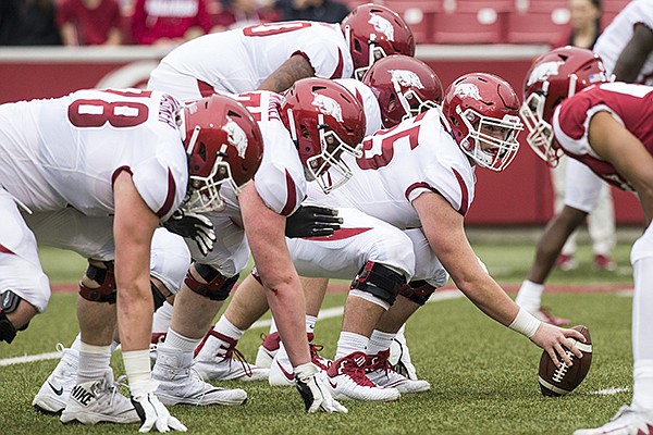 Arkansas linemen line up for a snap during a scrimmage Saturday, April 6, 2019, in Fayetteville. 