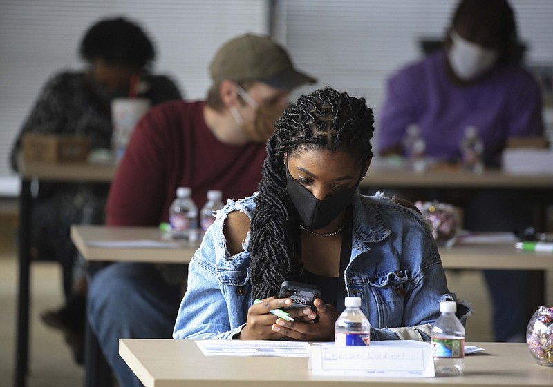 Chelsie Luckett uses a smartphone Tuesday, Aug. 4, 2020, in Little Rock to log onto a census app during a training class for door-to-door census takers in Pulaski County. About 300 people were to be trained over the week to canvass and knocking on doors between Aug. 11 and Sept. 30.