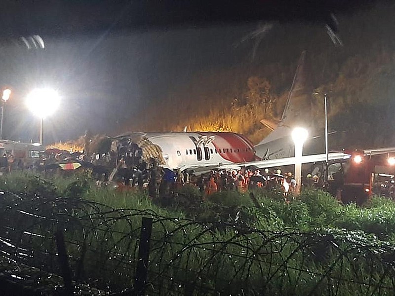 Emergency workers respond to the crash of an Air India Express flight Friday. More photos at arkansasonline.com/88india/.
(AP)