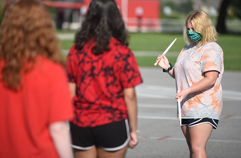 FILE — Lauren Holliman, a senior snare drum player with the Farmington High School Marching Band the Crimson Regiment, helps keep time Monday as the band works with coming to attention and standing at ease during practice at the high school in Farmington.