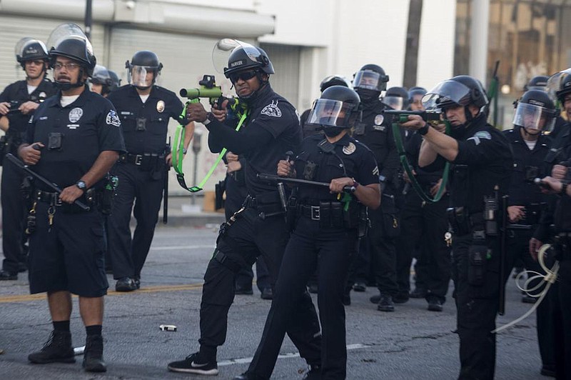 In this May photo, police officers re rubber bullets during a Los Angeles protest over the death of George Floyd. California lawmakers are pushing to enact nearly a dozen policing law changes driven by nationwide protests after Floyd’s death. (AP/Ringo H.W. Chiu) 