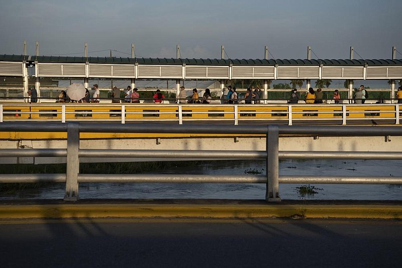 People form a line and wait to enter the United States on the Gateway International Bridge at Brownsville, Texas. (Bloomberg/Callaghan O’Hare) 