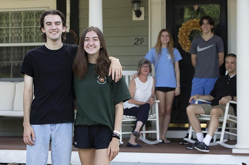 Matthew and Audrey Lorence stand in front of their home in Needham, Mass., on July 28. Usually all members of the Lorence family go to drop off the children attending college, but this year, due to the coronavirus pandemic, only the parents will go. (The New York Times/Katherine Taylor) 