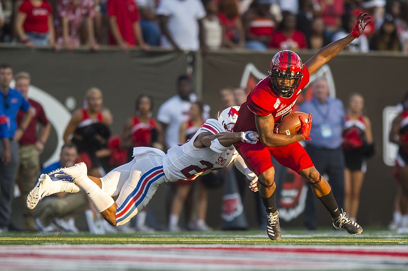 FILE — Arkansas State University Wide Receiver Jonathan Adams, Jr. (9) attempts to break a tackle during the game against the Southern Methodist University Mustangs at Centennial Bank Stadium in Jonesboro on Aug. 31, 2019.
