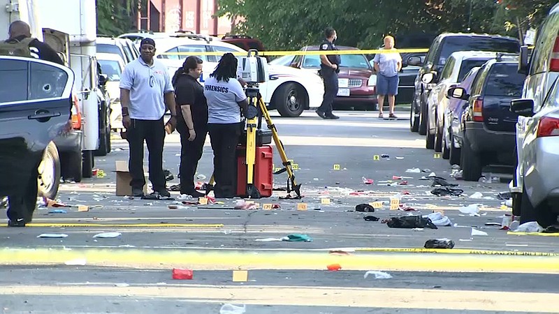 Law enforcement officials in Washington, D.C., work at the scene of Sunday’s shooting in this image from video provided by NBC4 Washington. (AP) 
