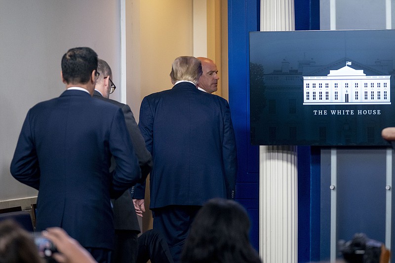 President Donald Trump is asked to leave the James Brady Press Briefing Room by a member of the U.S. Secret Service during a news conference at the White House, Monday, Aug. 10, 2020. 