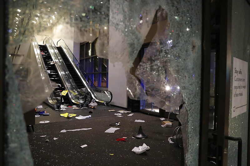 Glass is shattered in the Nordstrom store after a riot occurred in the Gold Coast area of the city early in the morning of Monday, Aug. 10, 2020 in Chicago.