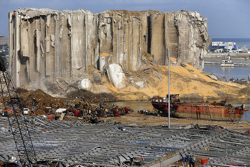 Earth moving equipment and rescue workers search for victims,Monday, Aug. 10, 2020, in Beirut, Lebanon, near the site of last week's explosion that hit the city's seaport.