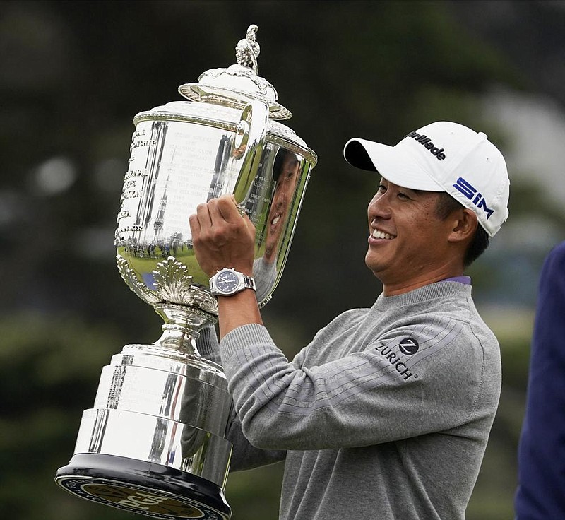 Collin Morikawa holds the Wanamaker Trophy after winning the PGA Championship on Sunday at TPC Harding Park in San Fran- cisco. Morikawa, who earned his first victory in a major in only his second attempt, closed with a 6-under 64, the lowest final round by a PGA champion in 25 years. (AP/Charlie Riedel) 