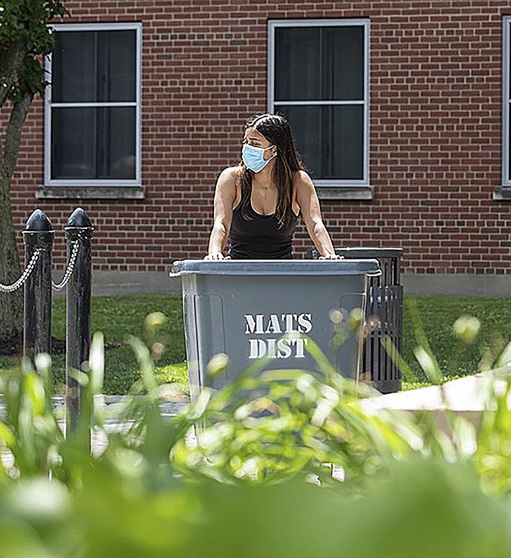 A student at Syracuse University in Syracuse, N.Y., wheels her belongings up a ramp earlier this month as she moves into her dorm. (AP/Syracuse University/Marilyn Hesler) 
