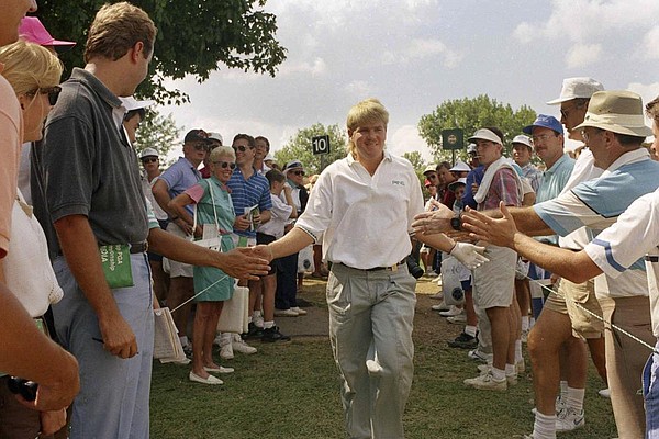 Former Arkansas Razorback John Daly is greeted by spectators during the final round of the 73rd PGA Championship in 1991. Daly went from being the ninth alternate to champion as he watched his popularity soar over the course of the weekend.
(AP file photo)