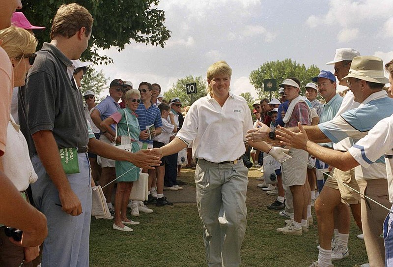 Former Arkansas Razorback John Daly is greeted by spectators during the final round of the 73rd PGA Championship in 1991. Daly went from being the ninth alternate to champion as he watched his popularity soar over the course of the weekend. (AP file photo) 