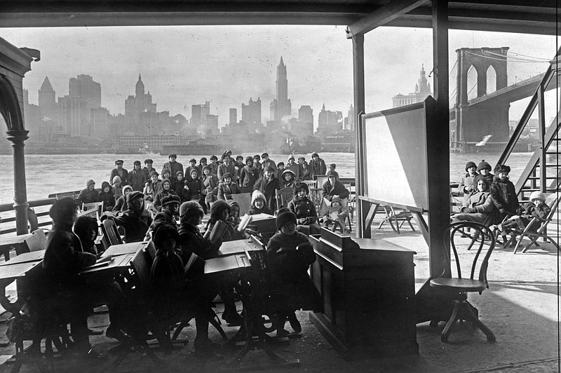 This 1911 photo shows schoolchildren on the ferry boat Rutherford near the Brooklyn Bridge in New York. With ventilation issues in school buildings across the U.S., some districts are looking at the idea of holding classes outdoors. (AP/Library of Congress) 