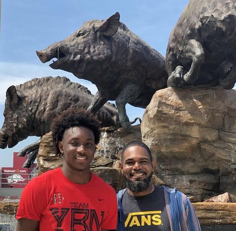 Chance Moore (left), pictured with his father John, said it was during their two-day visit to Fayetteville over the weekend that he made up his mind about committing to play basketball for Arkansas. (Photo courtesy Chance Moore) 